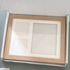 A wooden photo frame set with two clear glass panels for baby handprint and footprint memories.