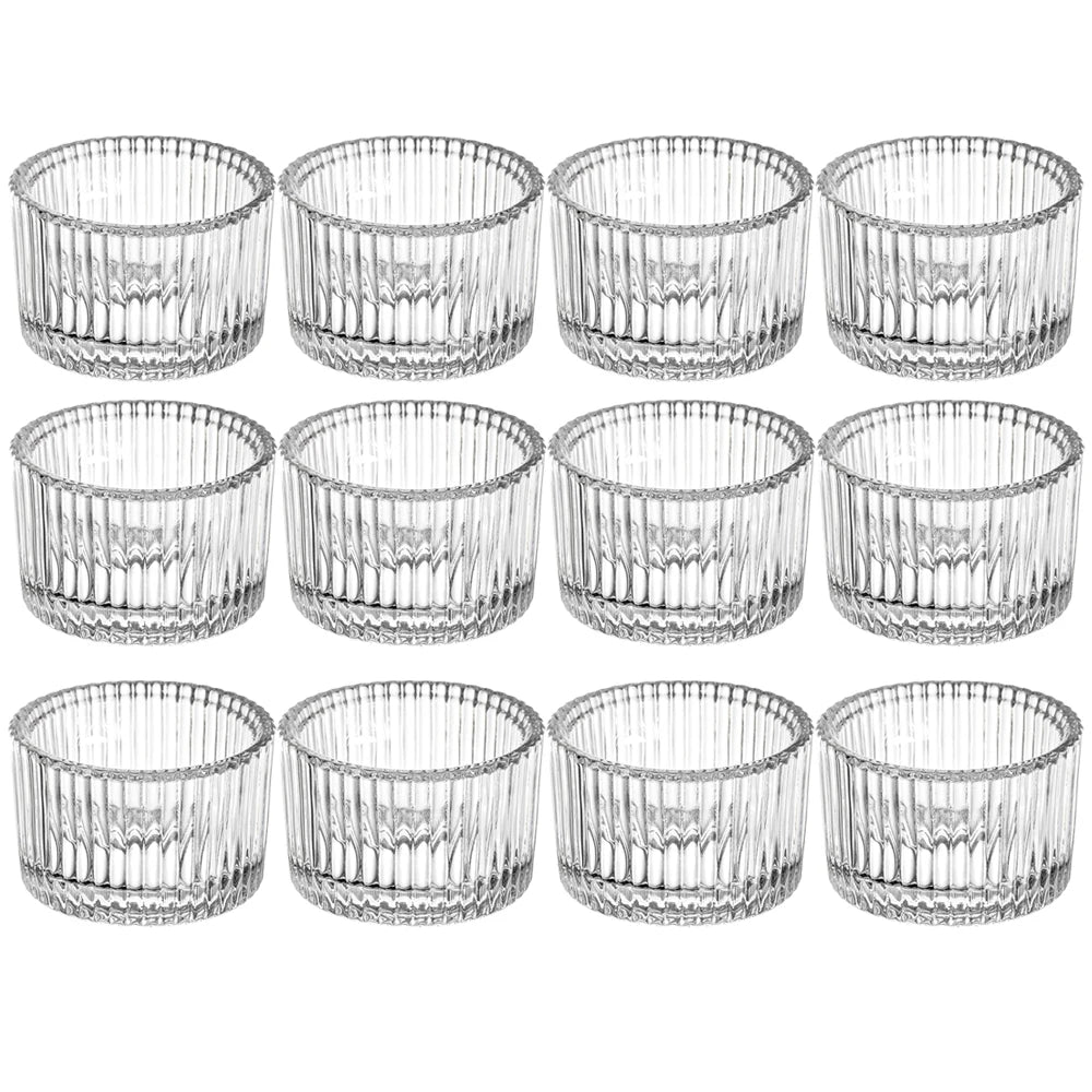A set of twelve clear glass tealight candle holders with intricate vertical fluting patterns.
