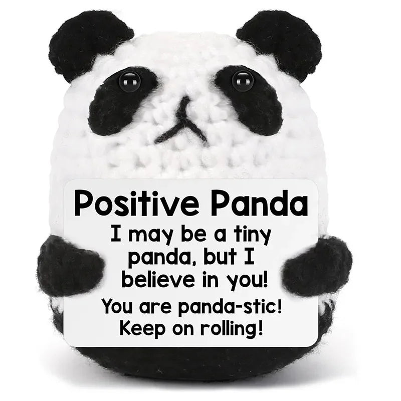 A white and black panda crochet doll with a positive message card that reads I may be a tiny panda but I believe in you You a