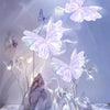 A cluster of translucent, iridescent silk artificial butterflies and floral decorations against a soft purple background.