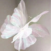 A delicate, translucent pink and white silk artificial butterfly decoration with light iridescent wings.