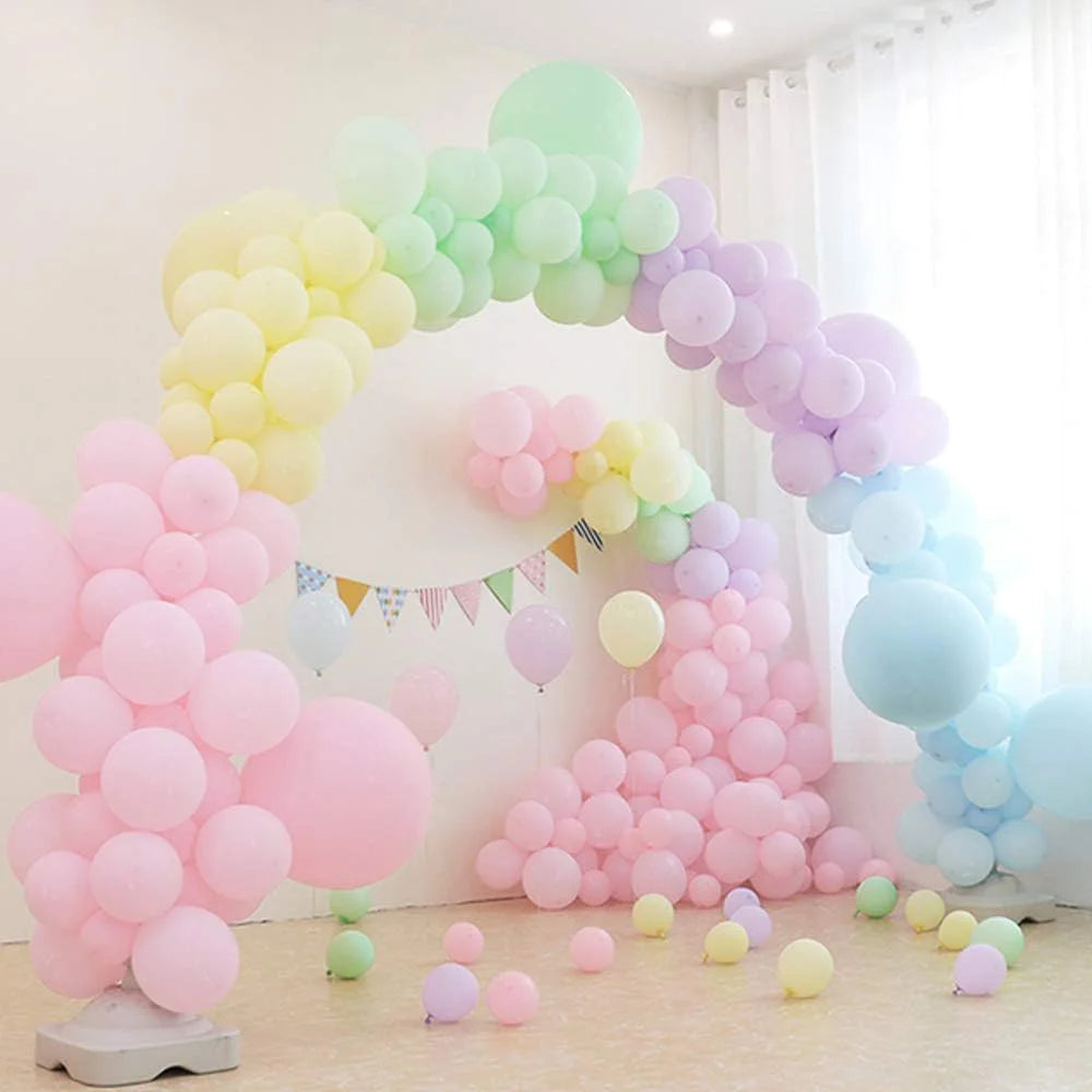 A colorful archway made of pastel rainbow latex balloons for party décor