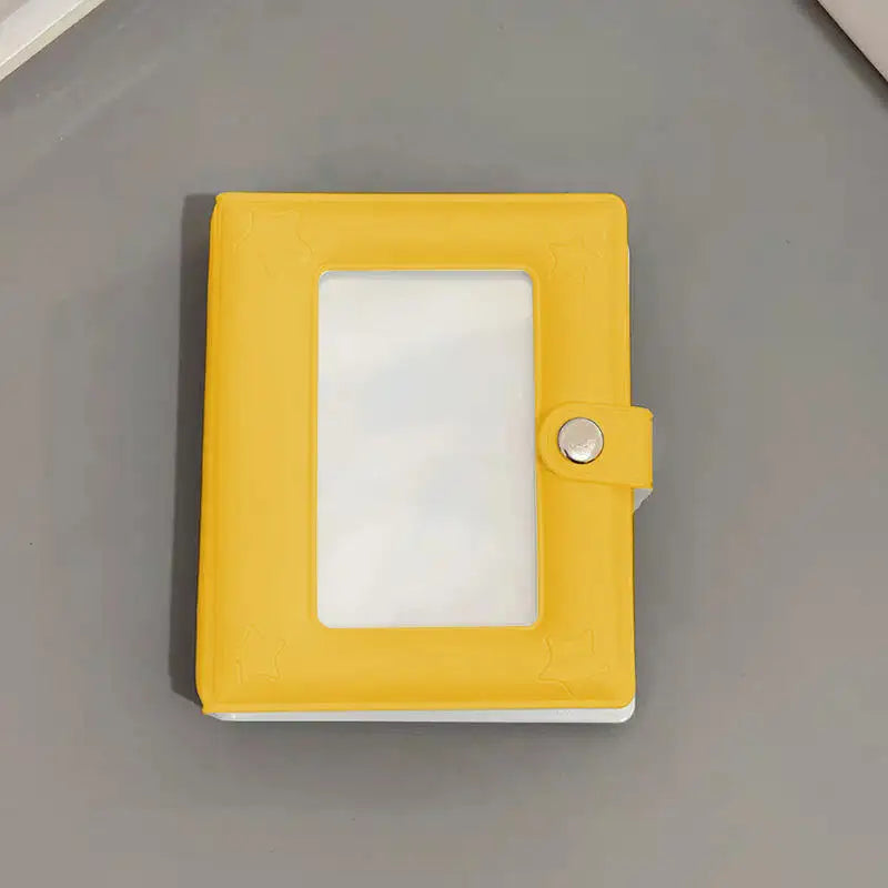 A yellow mini photo card binder with a clear plastic cover and a silver clasp.