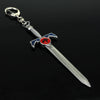 Silver metal sword keychain featuring a lion mark design with blue and red accents