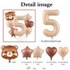 A set of foil balloons featuring a bear design and the number five in a caramel color.