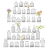 A collection of vintage bud glass vases and bottles arranged in a vertical display.