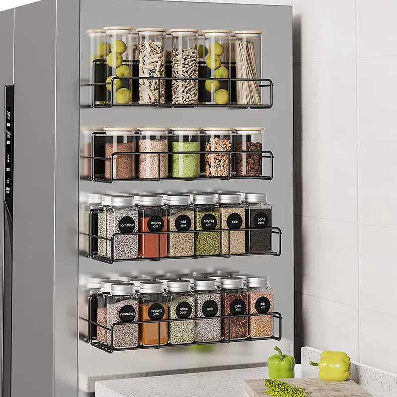 A magnetic spice rack for a refrigerator displaying various spices and herbs in glass jars.