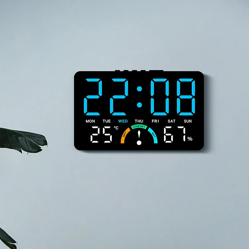 A digital alarm clock display showing 22:08, temperature 25°C, and humidity 67% on a gray wall.