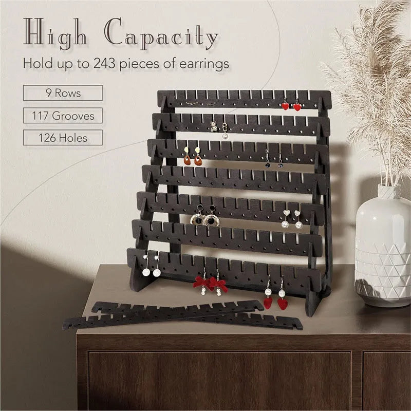 A black multilayer wooden earring organizer with 9 rows, 117 grooves, and 126 holes displaying various jewelry.