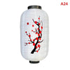 A white paper hanging lantern with a black top and red floral designs on the body.