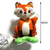 An orange fox-themed balloon decoration with large eyes and ears, shown next to a measuring tape.