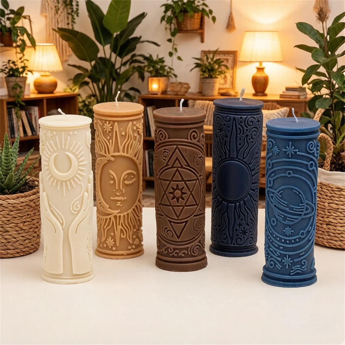 Four cylindrical silicone candle molds in white, tan, brown, and blue sit on a white surface.