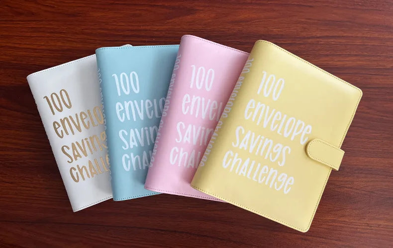 A set of three pastel-colored binders for the 100 Envelope Challenge, showing white, blue, and pink options.