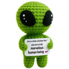 Handmade crochet green potato doll with large black eyes holding a card that says you are a truly marvelous human being
