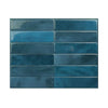 A rectangular panel of glossy blue-green self-adhesive tile stickers with varying shades and textures.
