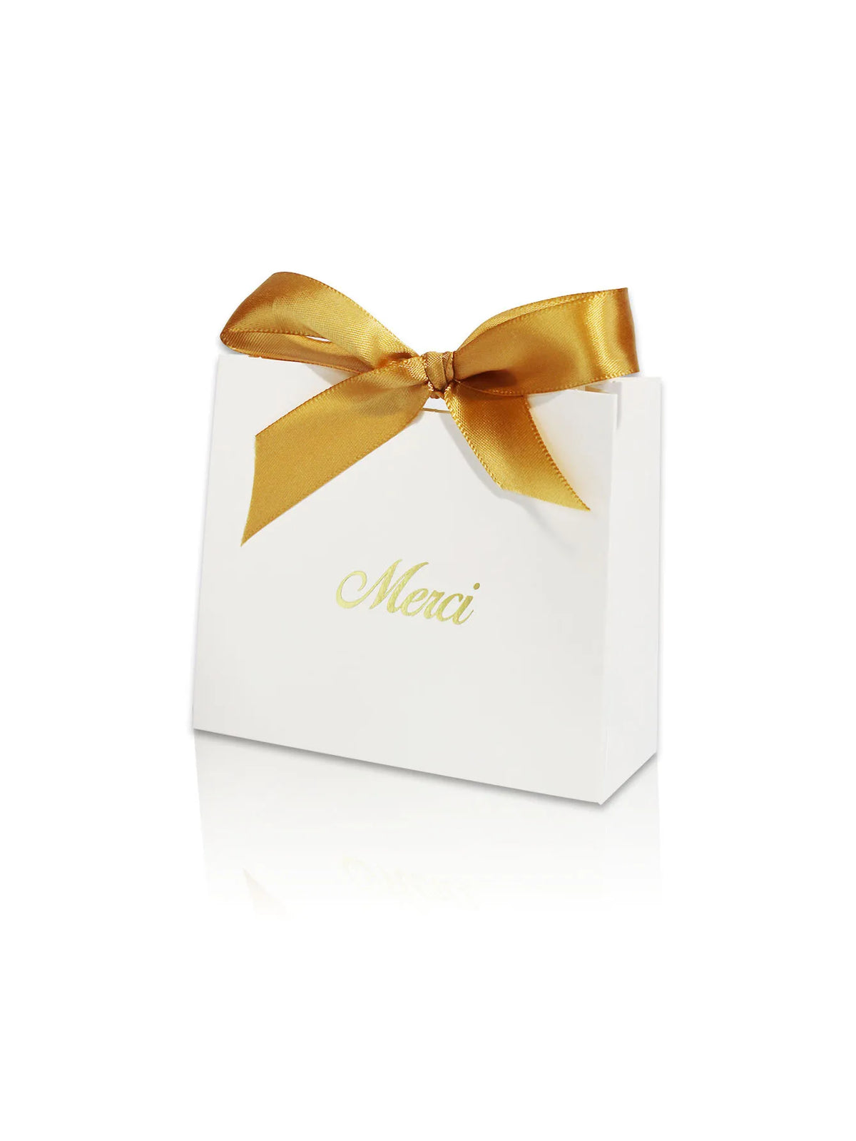 A white paperboard gift box tied with a gold ribbon and the word Merci written on the top.
