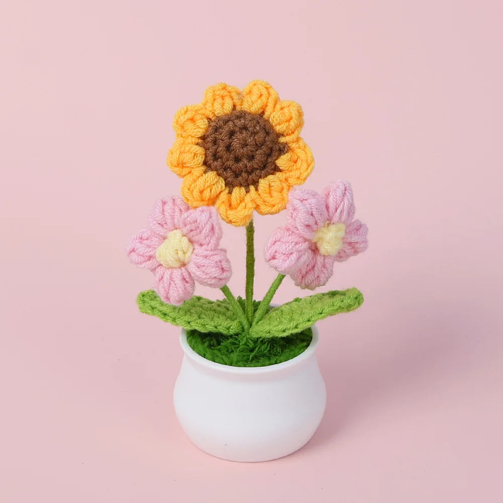 Hand woven crochet sunflower and pink flowers in a white pot