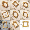 A collection of vintage gold DIY shadow box frames and decorative gold metal frames for memory display.