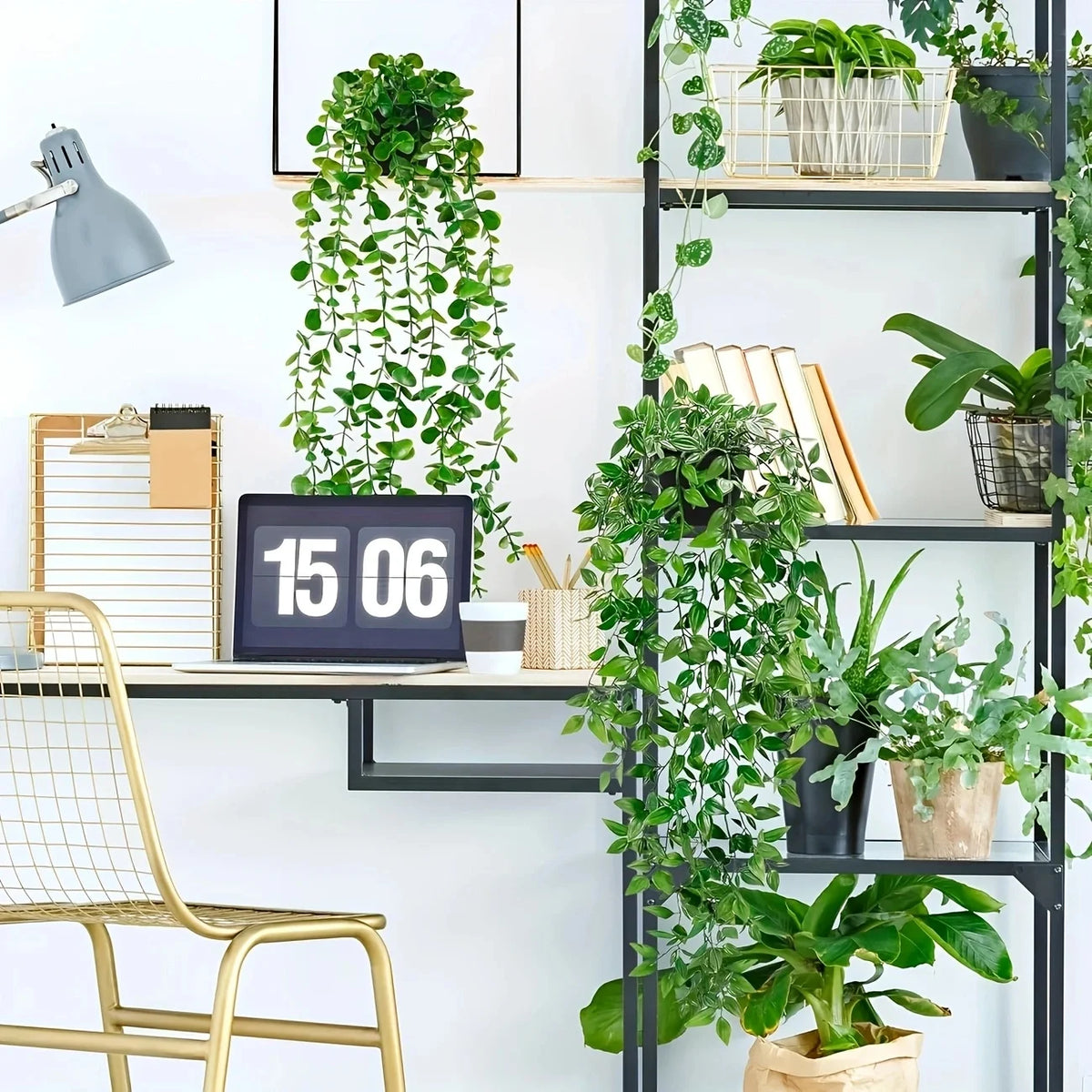 A display of artificial hanging plants in various pots and greenery against a white wall.