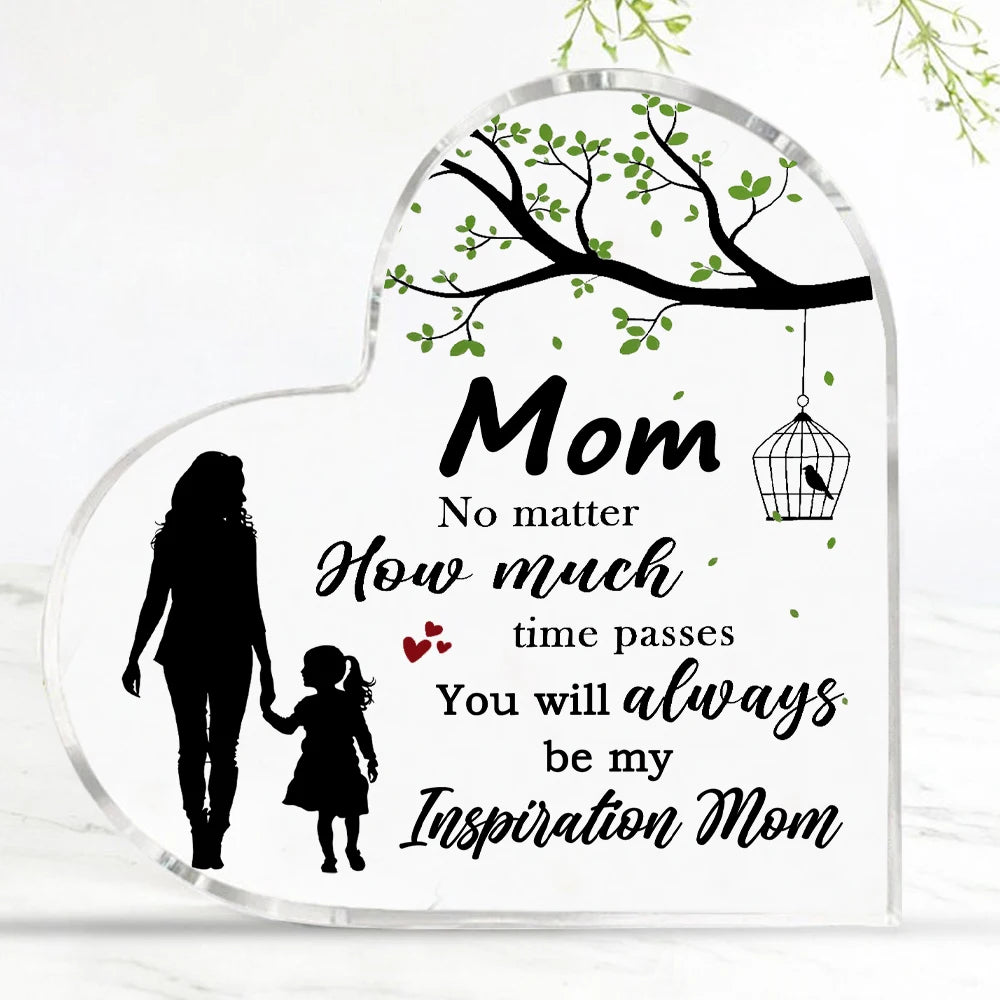 A clear acrylic heart-shaped plaque with a silhouette of a mother and a tree branch design and inspirational text