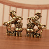 A pair of solid copper horse figurines for prosperity and positive energy, displayed on a wooden surface.
