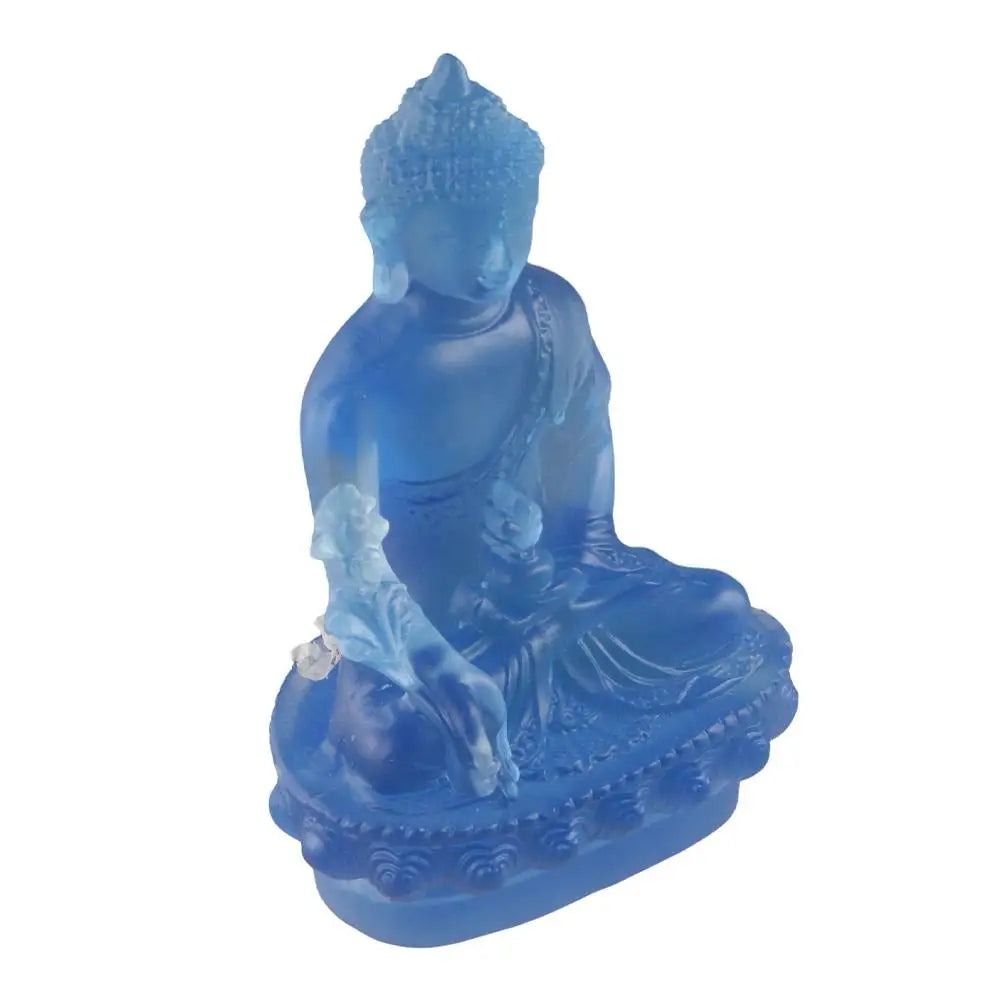 A blue resin statue of the Medicine Buddha seated in meditation.