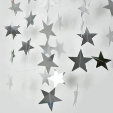 Silver and gold star paper garland bunting hanging in the air