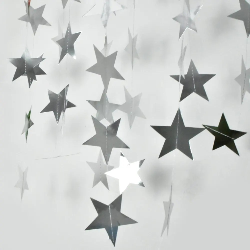 Silver and gold star paper garland bunting hanging in the air