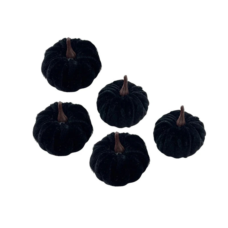 A set of five dark black foam pumpkins used for Halloween decoration.