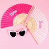 Two pink and white hand fans are displayed, one labeled Babe and the other Bride.