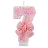 Pink glitter number seven candle with a pink bow for birthday or anniversary