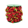 A cylindrical garland made of red roses, pearl beads, and green leaves on a green base.