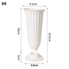 A tall white plastic decorative vase with vertical fluting and a flared base.