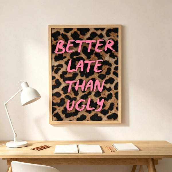 A framed canvas print featuring the text BETTER LATE THAN UGLY in bright pink script on a leopard print background.