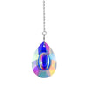 A hanging crystal suncatcher wind chime with a teardrop-shaped blue and iridescent glass pendant.
