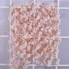 Pink sakura flower garland with delicate pink blossoms displayed on a white grid.