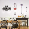 Farmhouse kitchen metal wall art sign featuring a silhouette of cutlery on a white wall.