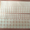 A sheet of glow-in-the-dark star wall stickers for kids, featuring various sized white circles on a translucent background.