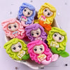 A collection of colorful resin figurines depicting mermaid princesses with curly hair and sweet expressions.