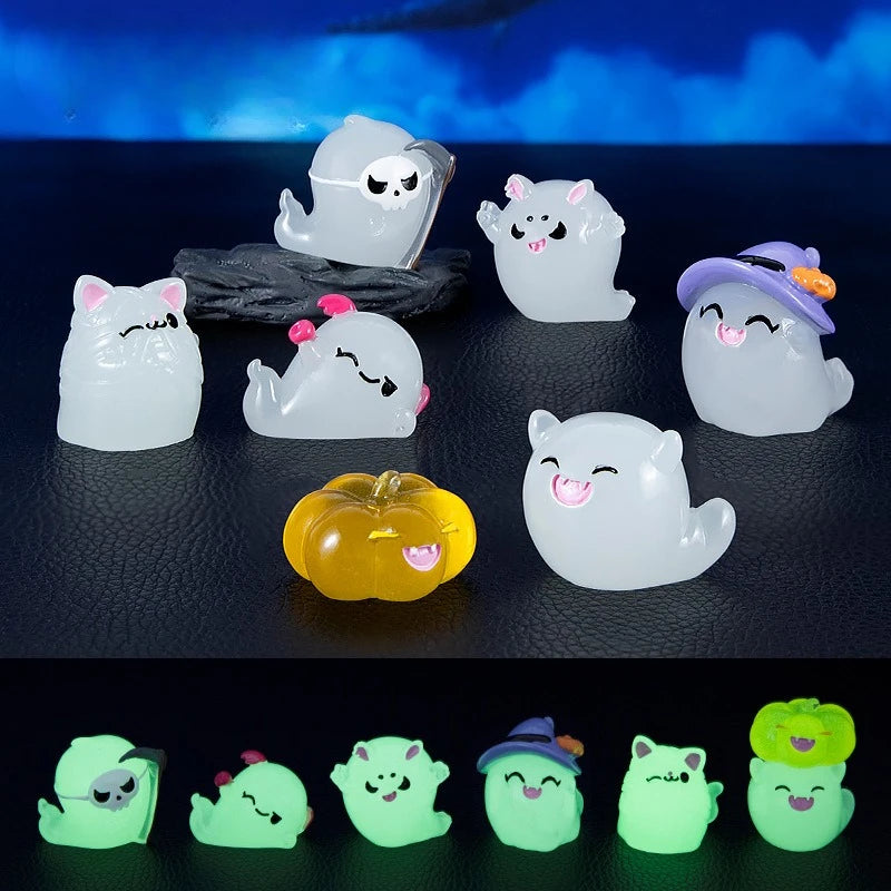 A set of seven luminous white and green ghost-shaped resin ornaments displayed on a dark surface.