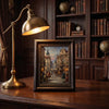A vintage dark wood photo frame with antique gold trim sits on a wooden table next to an antique brass desk lamp.