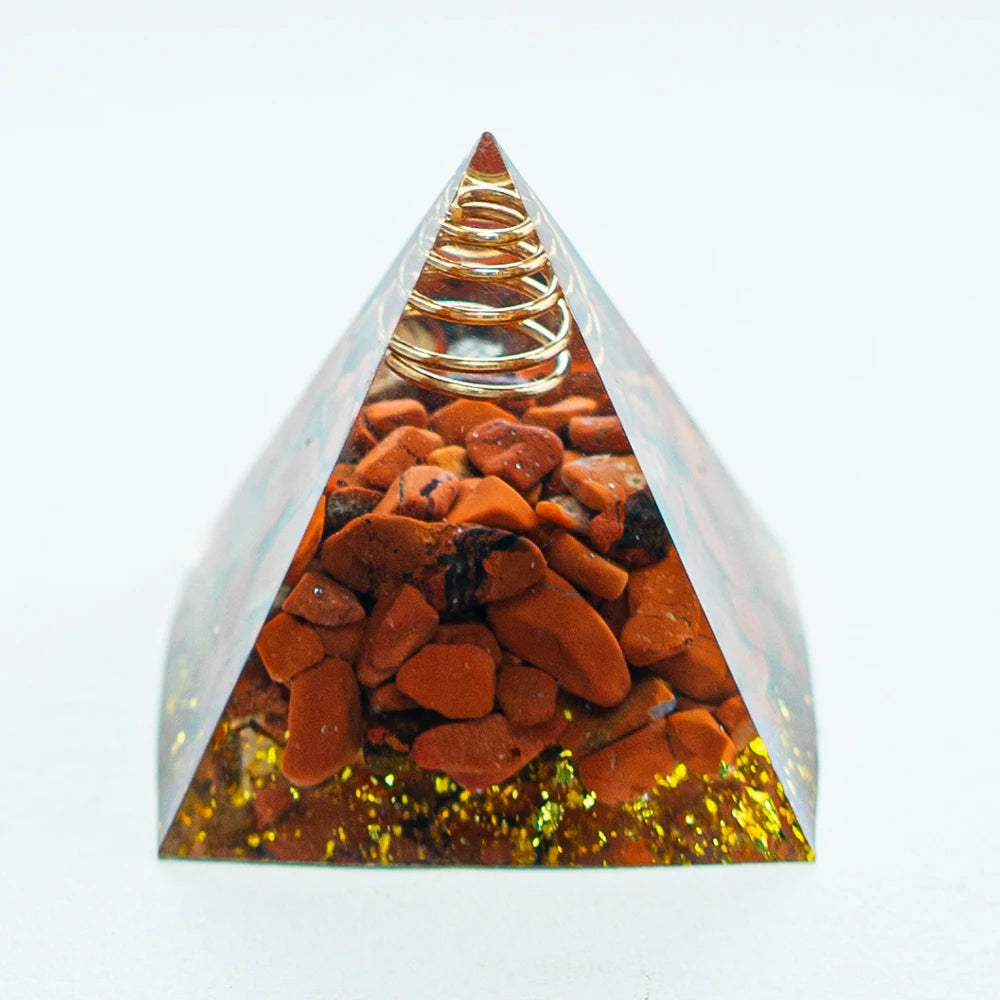 An amethyst crystal energy pyramid with a coiled wire at the apex, set in a clear glass structure.