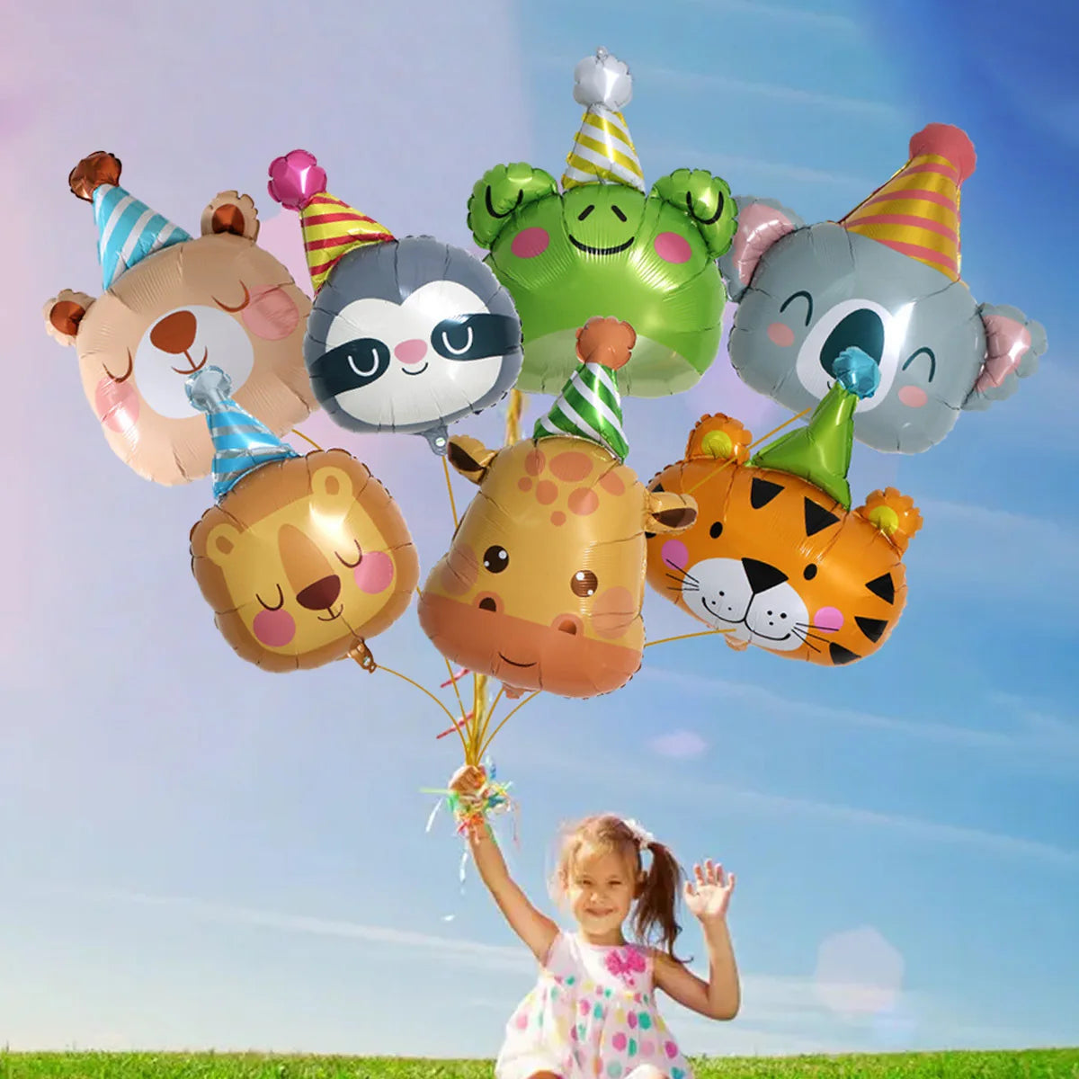 A girl is holding a bunch of colorful jungle animal foil balloons against a blue sky.