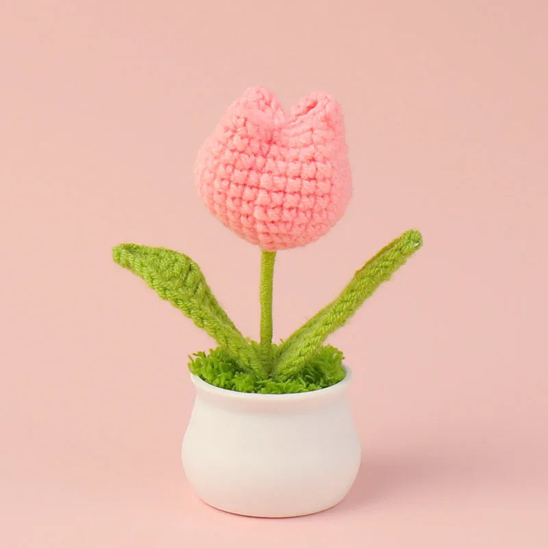 Hand woven pink crochet flower potted in a white ceramic cup