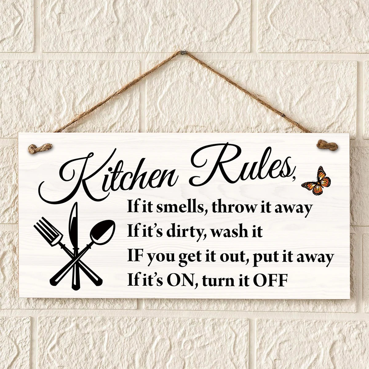 A white wooden sign with black text listing kitchen rules such as throwing away smelly items and turning off appliances.
