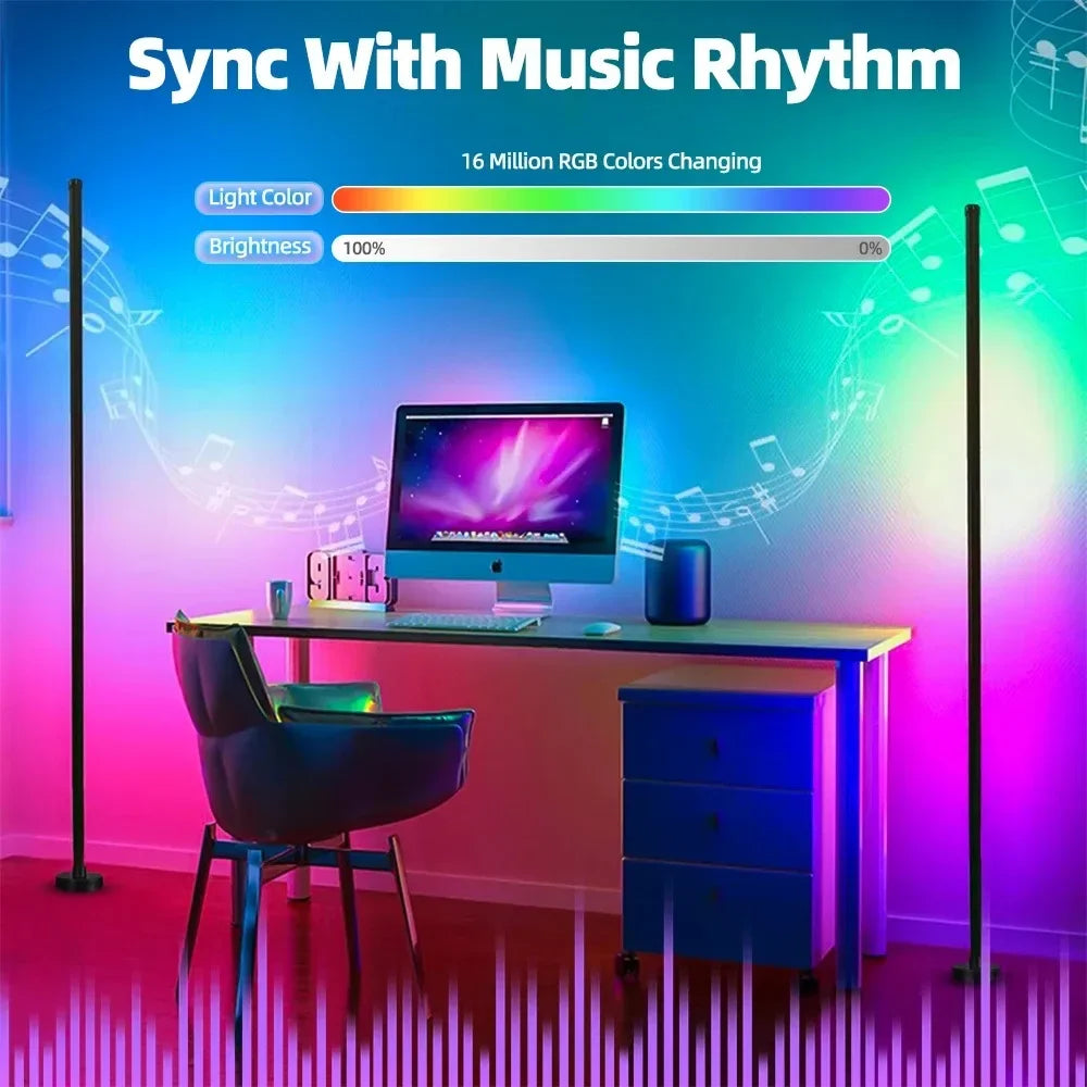 A desk setup featuring a computer monitor, keyboard, and a blue cabinet, illuminated by vibrant RGB light from floor lamps.
