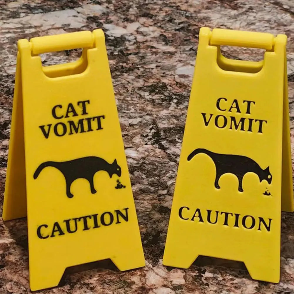 Two yellow plastic yard signs with black silhouettes of cats and dogs and the word CAUTION