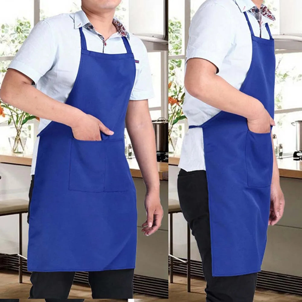A man wearing a royal blue waterproof kitchen apron with a front pocket, standing in a modern kitchen setting.