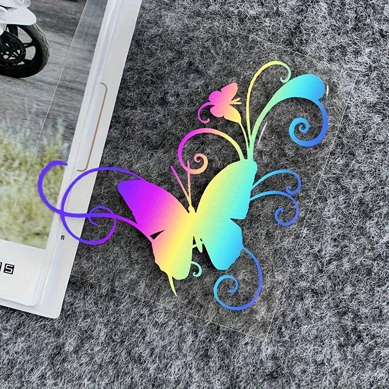 A colorful butterfly vinyl sticker with swirling lines is placed on a gray, textured surface.