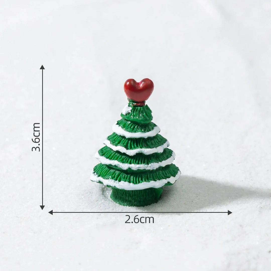A small, green resin Christmas tree charm with a red heart topper, shown against a white background.